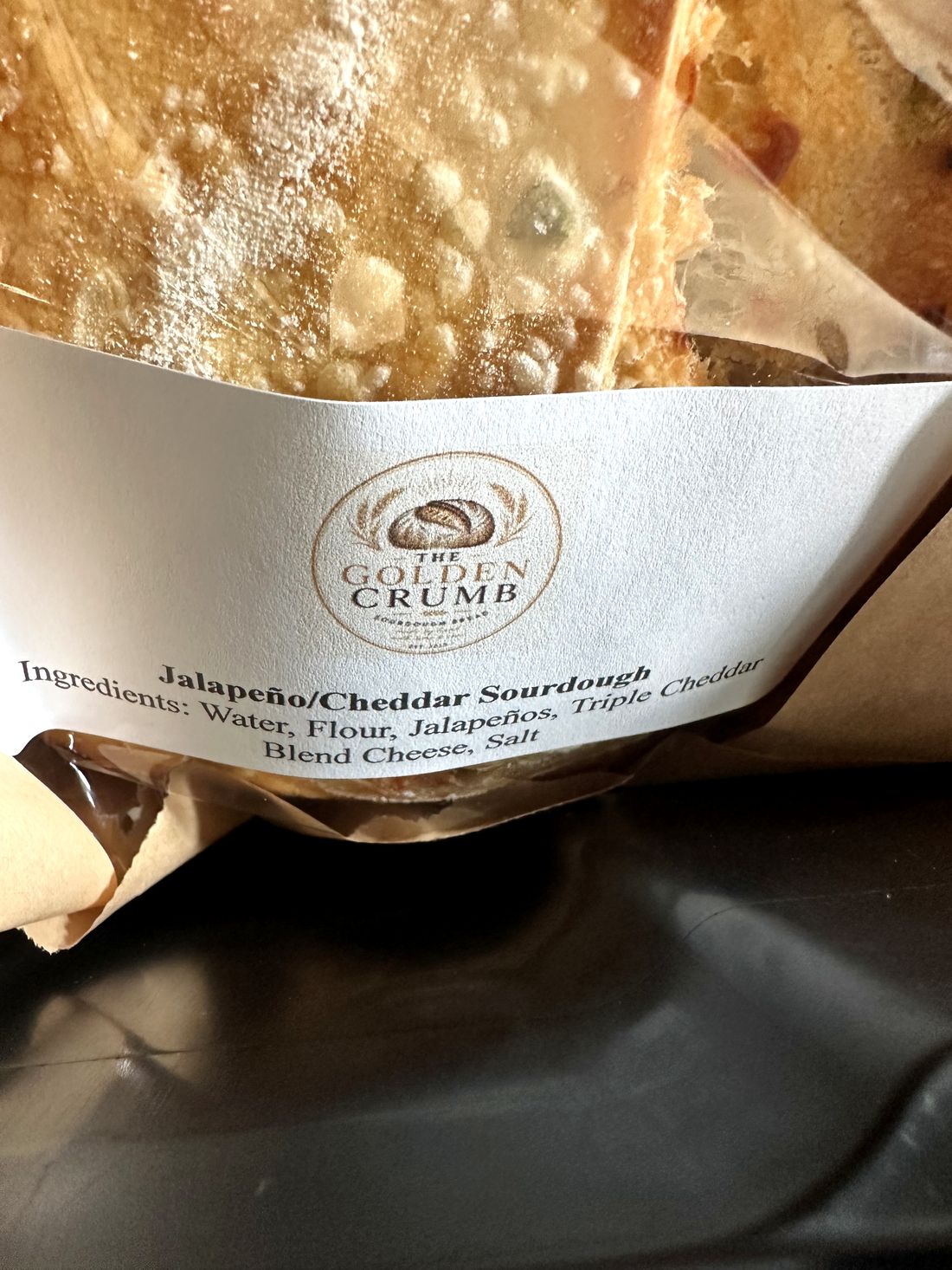 Jalapeño and cheddar sourdough loaf in branded packaging